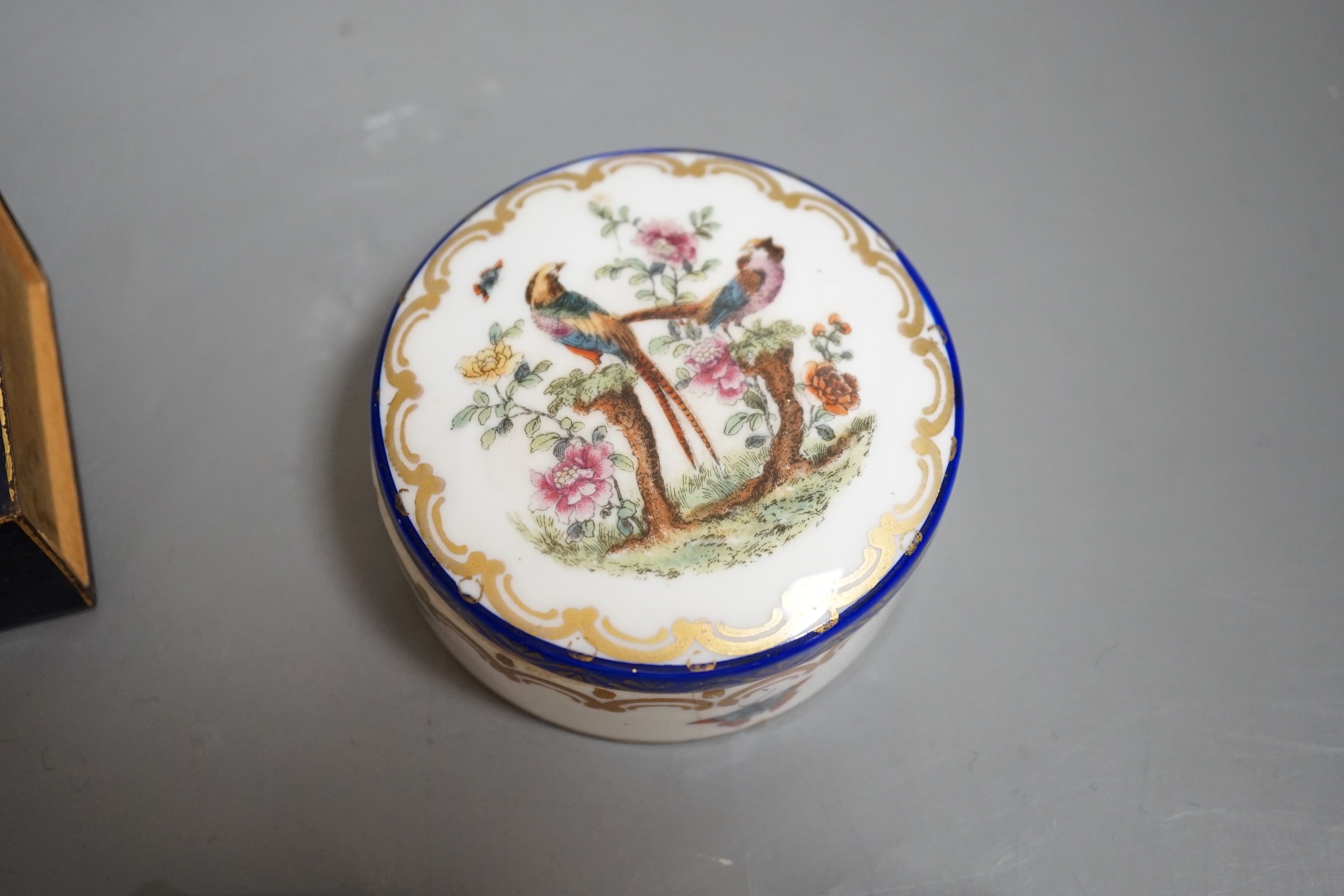 A Continental circular porcelain pot and cover, a plaque and a matchbox cover